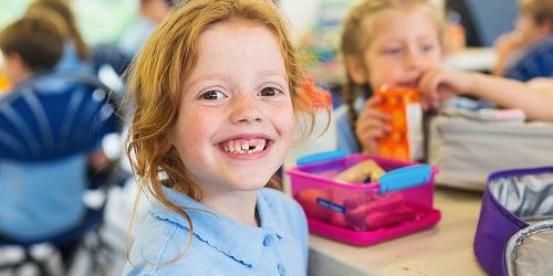 Young boy whose front tooth is missing