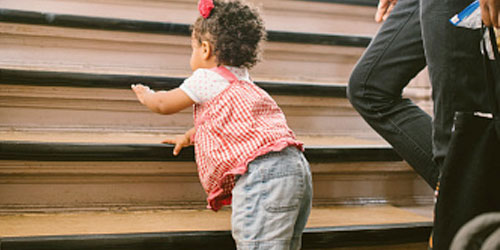 Toddler ascending a staircase