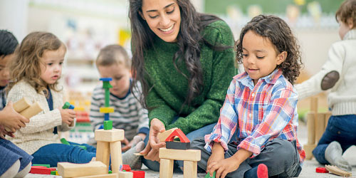 Early childhood teacher interacting with young children